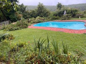 a swimming pool in a yard next to a field at The Orchard in Hilton