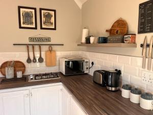 a kitchen with a counter top with a microwave at The Orchard in Hilton