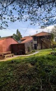 a house with a picnic table in a yard at Domaine de Calabel in Pouylebon