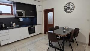 a kitchen with a table and chairs in a room at RG Apartments in Šamorín +15 photos