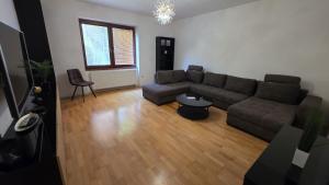 a living room with a couch and a table at RG Apartments in Šamorín