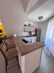 a kitchen with a counter with a sink and a stove at Residence Mangrove Saly in Ngaparou