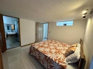 a small bedroom with a bed and a bathroom at Seaside View Terrace Apartment in Mauritius +12 photos