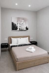 a bedroom with a bed with two towels on it at 9-4 Private Houses in Kos