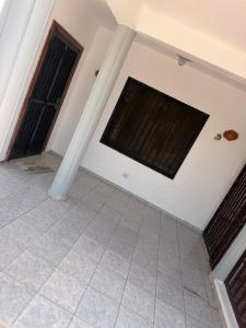 a room with a tiled floor and two windows at Mary Vilaseca in SJM