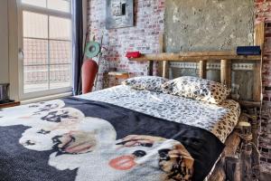 a bedroom with a dog blanket on a bed at Be my Guest House in Wijk aan Zee