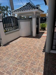 a patio with a fence and a tile floor at Mary Vilaseca in SJM