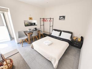 a bedroom with a bed and a table with chairs at 9-4 Private Houses in Kos