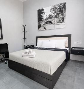 a bedroom with a bed with towels on it at 9-4 Private Houses in Kos