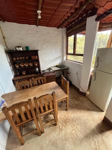 a kitchen with a table and chairs and a refrigerator at La Misión Hotel Chignahuapan in Chignahuapan