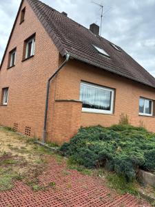 a red brick house with a roof at Sylbacher Gästehaus in Bad Salzuflen