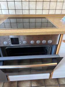 a stove top oven sitting inside of a kitchen at Sylbacher Gästehaus in Bad Salzuflen