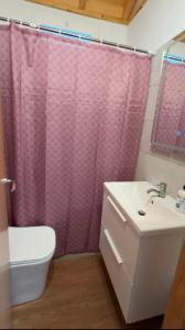 a bathroom with a pink shower curtain and a sink at VV Casa Los Brezos "by AFCVacacional" in Breña Alta +19 photos