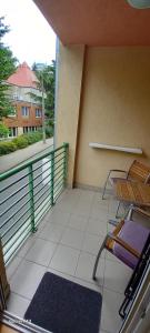 a balcony with chairs and a view of a building at Favorite apartment in Hévíz