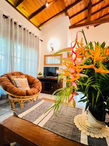 a living room with a chair and a table at Onadi House in Galle
