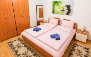 a bedroom with a bed with two blue pillows on it at Villa Indigo in Berovo