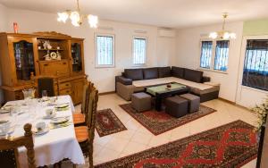 a living room with a couch and a table at Villa Indigo in Berovo