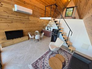 a living room with a television and a table and chairs at The Quiet Wild in Briska Gora