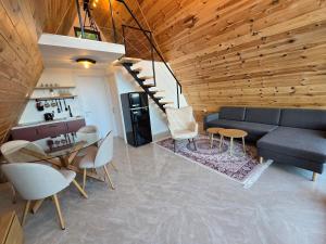 a living room with a couch and a table and chairs at The Quiet Wild in Briska Gora