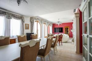 a dining room and living room with a table and chairs at La Coraillère Waterfront Villa with Private Pool and Sea Access in Théoule-sur-Mer