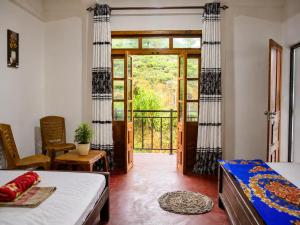 a bedroom with a bed and a door to a balcony at Haputala Blossom guest in Haputale
