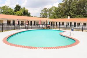 a large swimming pool with a building in the background at 7 Gables Motel Burnside Near Somerset US 27 in Burnside