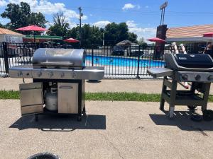 a grill and smoker next to a swimming pool at 7 Gables Motel Burnside Near Somerset US 27 in Burnside