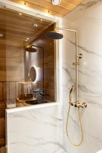 a bathroom with a shower and a sink at Sugar Factory Apartments in Kotka