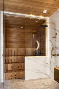 a bathroom with a glass walled shower at Sugar Factory Apartments in Kotka