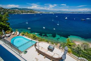 a view of a body of water with a swimming pool at La Coraillère Waterfront Villa with Private Pool and Sea Access in Théoule-sur-Mer
