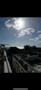 a view of a building with the sun in the sky at Seaside View Terrace Apartment in Mauritius