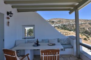 a table and chairs on a porch with a view at Anastasia Home in Triandáros