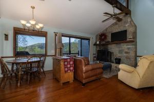 a living room with a couch and a table and a fireplace at Eagle Point - Powder Horn Mountain in Powderhorn Mountain