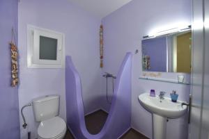 a bathroom with a toilet and a sink at Anastasia Home in Triandáros +25 photos