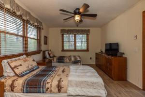a bedroom with a bed and a ceiling fan at Eagle Point - Powder Horn Mountain in Powderhorn Mountain +32 photos