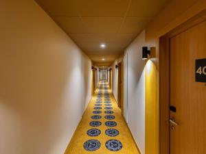 a long hallway with blue plates on the floor at ibis Styles Metz Centre in Metz