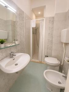 a bathroom with a sink and a toilet and a shower at Hotel Malibù in Rimini +54 photos