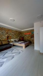 a room with a bed and a stone wall at Guest House Nadol SUP and Bikes included in Ohrid
