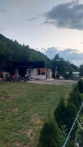 a building with motorcycles parked in front of a field at Guest House Nadol SUP and Bikes included in Ohrid