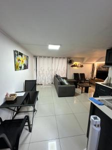 a large living room with a couch and chairs at Seaside View Terrace Apartment in Mauritius