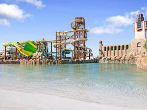 a water park with a water slide in the water at Rixos Murjana - Ultra All Inclusive in King Abdullah Economic City