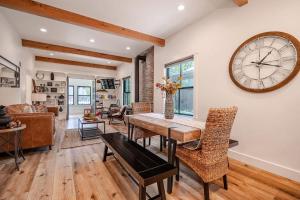 a dining room with a table and a large clock on the wall at Downtown Truckee Walkable 6 Bed Pet Friendly in Truckee