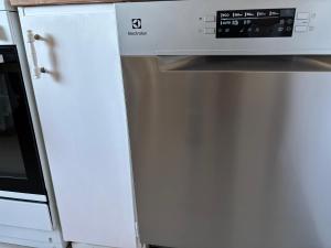 a microwave oven sitting on top of a refrigerator at Viksjo Centrum Apartment in Järfälla +4 photos