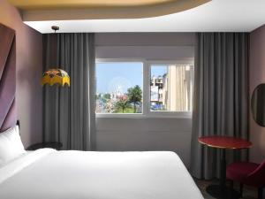 a hotel room with a bed and a window at IBIS STYLES KINSHASA in Kinshasa +79 photos