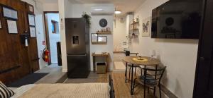 a kitchen with a small table and a refrigerator at Studio apartman King with private jacuzzi and sauna in Štakorovec