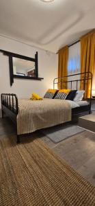 a bedroom with a bed with a mirror on the wall at Studio apartman King with private jacuzzi and sauna in Štakorovec