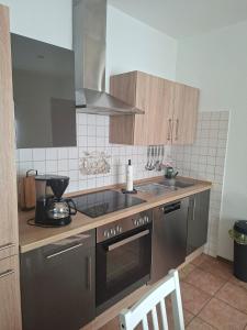 a kitchen with a sink and a stove top oven at Ferienhaus Petig in Pritzerbe
