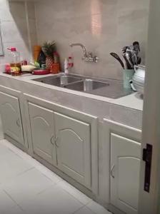a kitchen with a sink and a counter at Villa S in Ouagadougou
