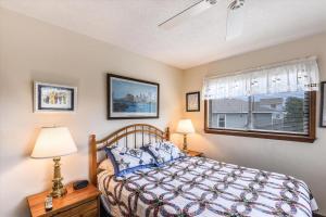 a bedroom with a bed and a window at Hurricane Charlie's in Duck +17 photos