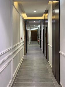 a hallway of an office building with a tile floor at Vinpy hotels in Uyo